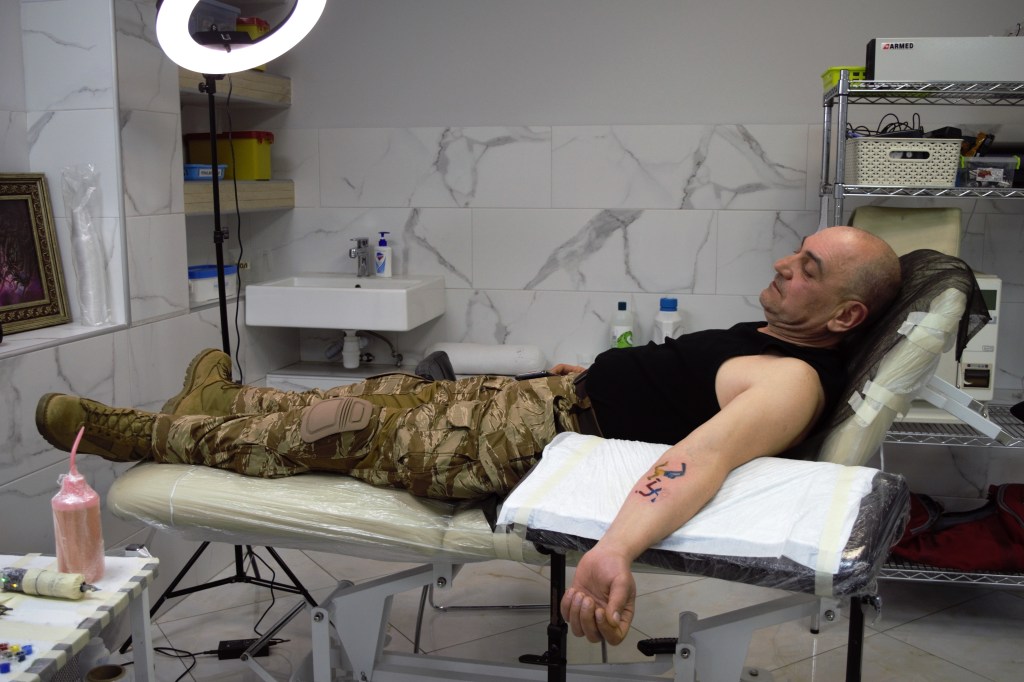 Sergey was given a few hours leave from duty to get his tattoo. After weeks of war he lies down to get inked. Joti Heir/Kyiv