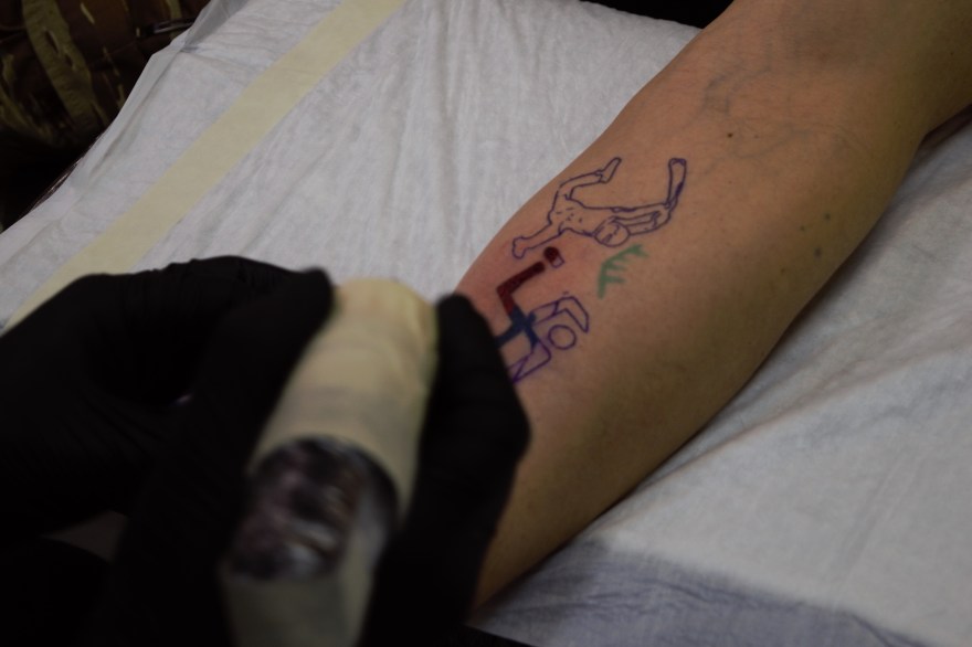 Volodymr works on a tattoo in Kyiv Ukrain